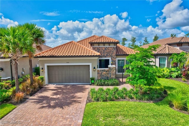 8142 Lucello Ter S, Naples, FL 34114 - mediterranean / spanish-style home with an attached garage, stucco siding, decorative driveway, a tile roof, and stone siding