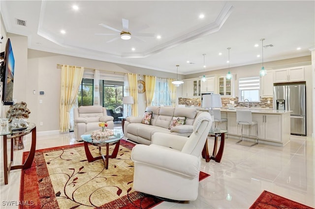 8142 Lucello Ter S, Naples, FL 34114 - living room with a ceiling fan, plenty of natural light, ornamental molding, a raised ceiling, and light marble finish flooring