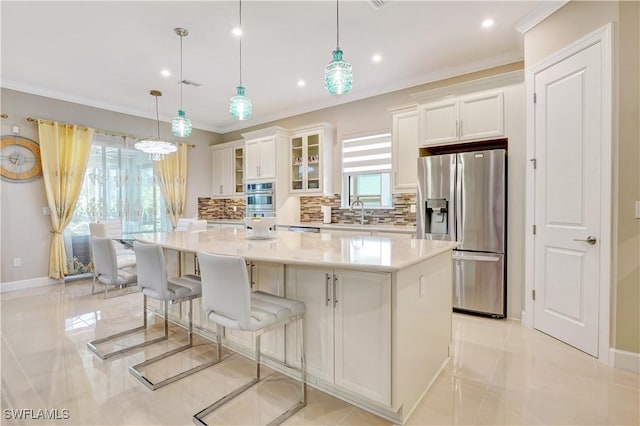 8142 Lucello Ter S, Naples, FL 34114 - kitchen with stainless steel refrigerator with ice dispenser, decorative backsplash, white cabinets, a large island, and ornamental molding