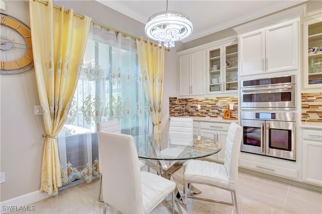 8142 Lucello Ter S, Naples, FL 34114 - dining area with a chandelier, plenty of natural light, light tile patterned floors, and ornamental molding