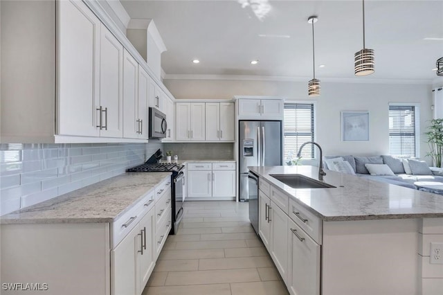14712 Kingfisher Loop, Naples, FL 34120 - kitchen featuring stainless steel appliances, backsplash, white cabinets, crown molding, and open floor plan