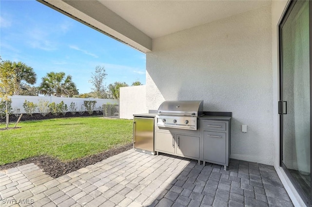 14712 Kingfisher Loop, Naples, FL 34120 - fenced backyard featuring an outdoor kitchen and a patio