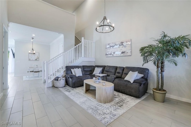 14712 Kingfisher Loop, Naples, FL 34120 - living room with a chandelier, stairway, ornamental molding, and a towering ceiling