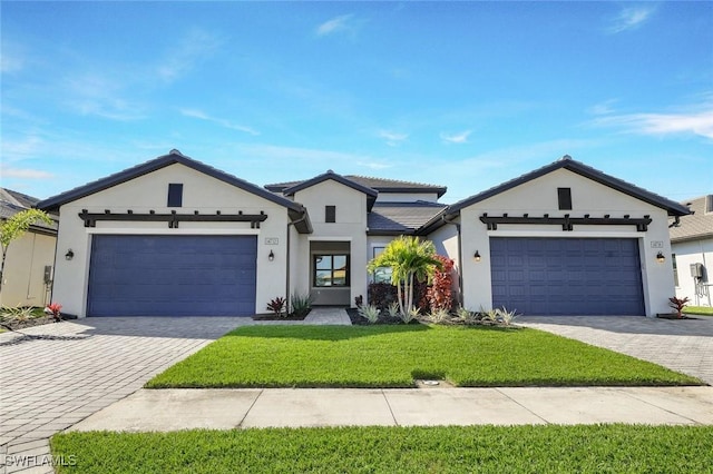 14712 Kingfisher Loop, Naples, FL 34120 - modern inspired farmhouse with an attached garage, decorative driveway, a front yard, and stucco siding