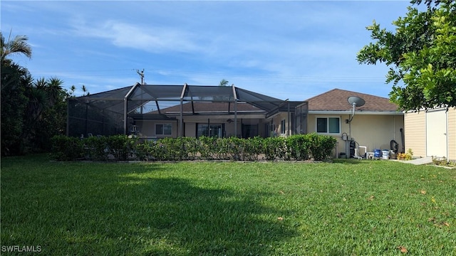 169 SE 21st St, Cape Coral, FL 33990 - rear view of house featuring a lawn, stucco siding, and a lanai