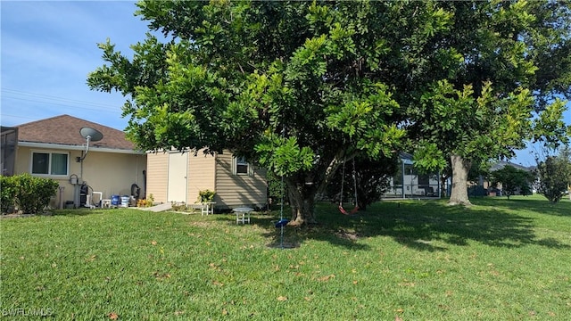 169 SE 21st St, Cape Coral, FL 33990 - rear view of house with a lawn, stucco siding, and an outbuilding