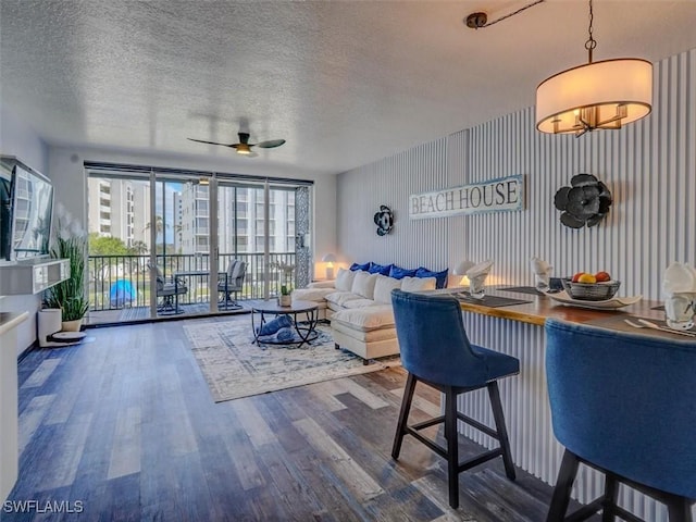 4431 Bay Beach Ln Unit 522, Fort Myers Beach, FL 33931 - living area with ceiling fan, wood finished floors, and a textured ceiling