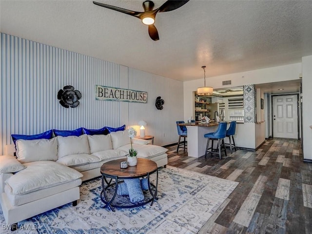 4431 Bay Beach Ln Unit 522, Fort Myers Beach, FL 33931 - living room with ceiling fan, dark wood finished floors, and a textured ceiling