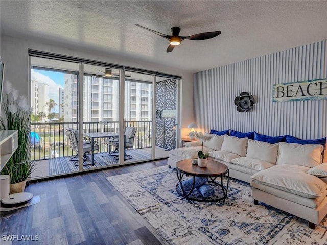4431 Bay Beach Ln Unit 522, Fort Myers Beach, FL 33931 - living area featuring a ceiling fan, a textured ceiling, and wood finished floors