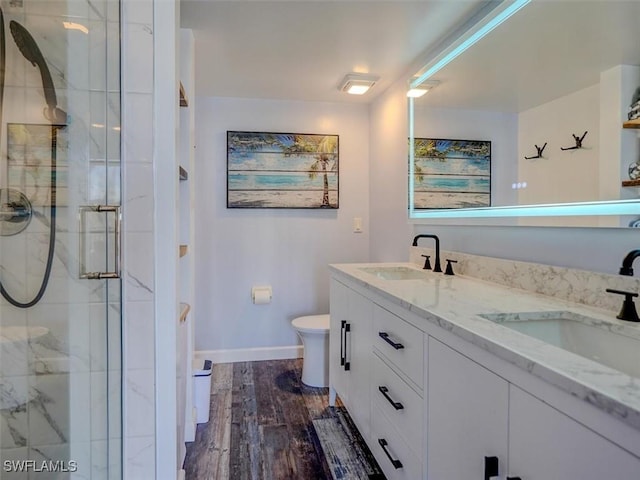 4431 Bay Beach Ln Unit 522, Fort Myers Beach, FL 33931 - bathroom featuring a marble finish shower, double vanity, and wood finished floors