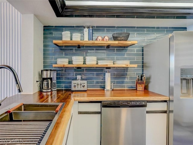 4431 Bay Beach Ln Unit 522, Fort Myers Beach, FL 33931 - kitchen featuring appliances with stainless steel finishes, open shelves, wooden counters, and white cabinetry