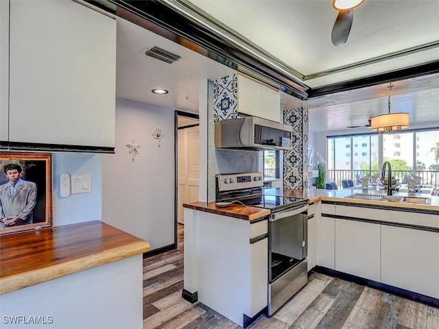 4431 Bay Beach Ln Unit 522, Fort Myers Beach, FL 33931 - kitchen featuring appliances with stainless steel finishes, wooden counters, white cabinets, light wood finished floors, and a ceiling fan