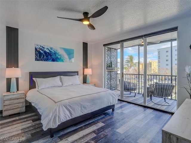 4431 Bay Beach Ln Unit 522, Fort Myers Beach, FL 33931 - bedroom featuring access to outside, wood finished floors, multiple windows, a textured ceiling, and a ceiling fan