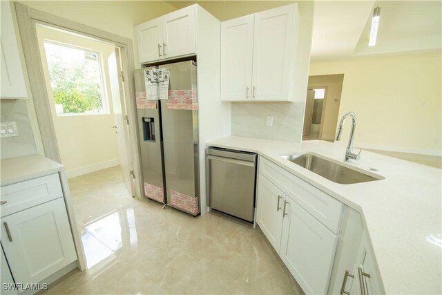 3407 E 5th St, Lehigh Acres, FL 33972 - kitchen featuring stainless steel appliances, white cabinetry, light countertops, and light marble finish floors