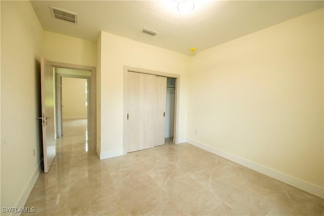 3407 E 5th St, Lehigh Acres, FL 33972 - unfurnished bedroom with light marble finish floors and a closet
