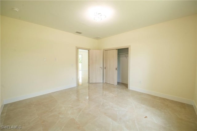 3407 E 5th St, Lehigh Acres, FL 33972 - unfurnished bedroom with a closet and light marble finish flooring