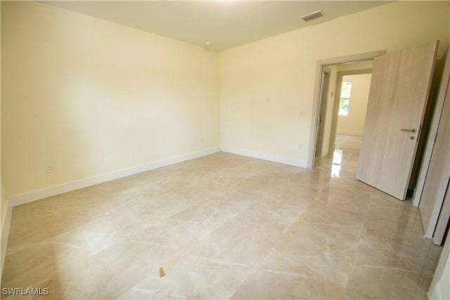 3407 E 5th St, Lehigh Acres, FL 33972 - empty room featuring light marble finish flooring and baseboards