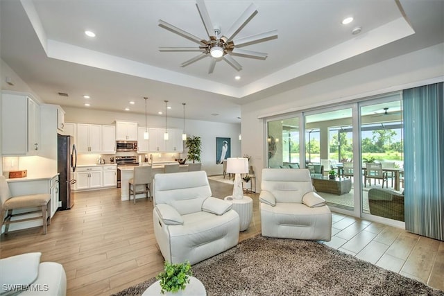 3649 Avenida Del Vera, North Fort Myers, FL 33917 - living area featuring a ceiling fan, a tray ceiling, light wood finished floors, and recessed lighting