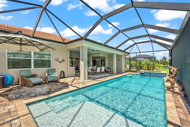 3649 Avenida Del Vera, North Fort Myers, FL 33917 - outdoor pool featuring a patio area, a hot tub, ceiling fan, outdoor dining area, and a lanai