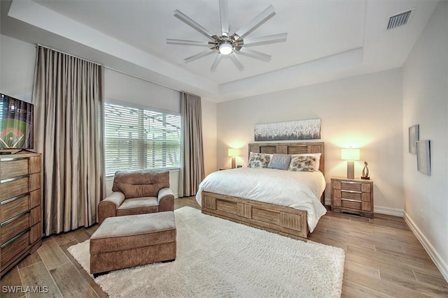 3649 Avenida Del Vera, North Fort Myers, FL 33917 - bedroom with a tray ceiling, wood finished floors, and ceiling fan