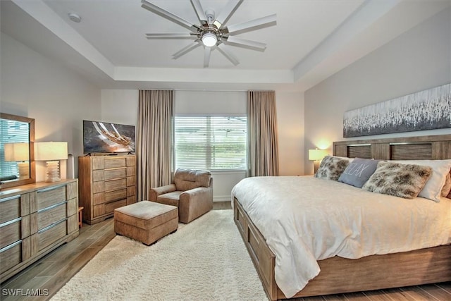 3649 Avenida Del Vera, North Fort Myers, FL 33917 - bedroom featuring a raised ceiling, wood finished floors, and a ceiling fan