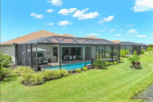 3649 Avenida Del Vera, North Fort Myers, FL 33917 - rear view of house with a yard, a tiled roof, glass enclosure, and an outdoor pool