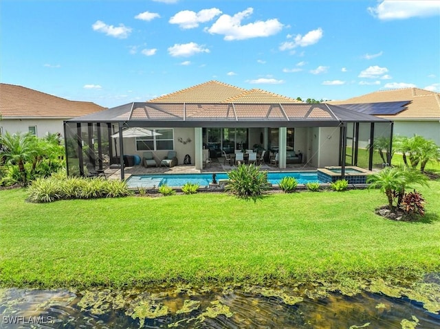3649 Avenida Del Vera, North Fort Myers, FL 33917 - rear view of house featuring a yard, a pool with connected hot tub, a lanai, and a tile roof