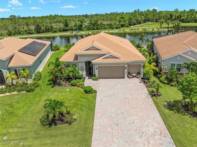3649 Avenida Del Vera, North Fort Myers, FL 33917 - view of front of house with a garage, a tile roof, decorative driveway, stucco siding, and a water view