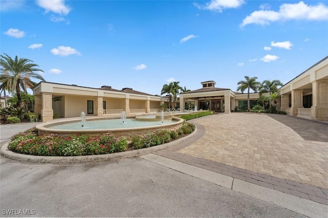 580 El Camino Real Unit 3606, Naples, FL 34119 - view of front facade with stucco siding and driveway