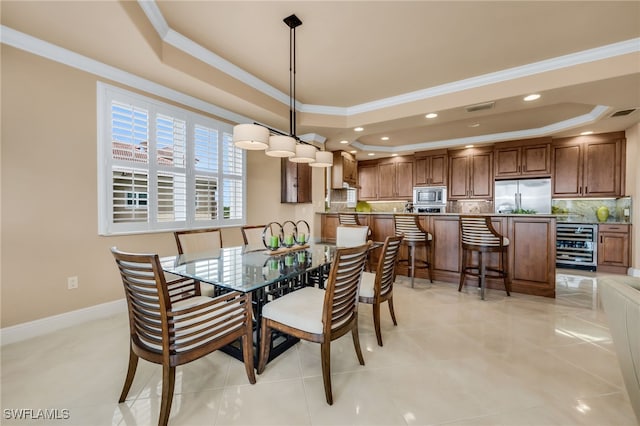 580 El Camino Real Unit 3606, Naples, FL 34119 - dining room with a raised ceiling, ornamental molding, wine cooler, and recessed lighting