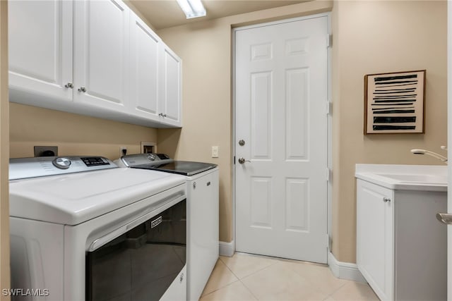 580 El Camino Real Unit 3606, Naples, FL 34119 - laundry room with independent washer and dryer, cabinet space, and light tile patterned floors