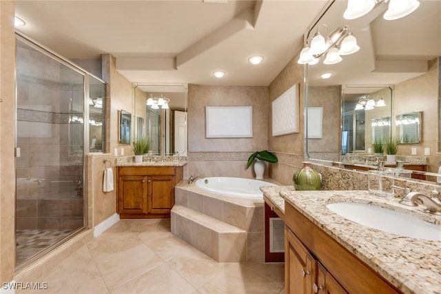 580 El Camino Real Unit 3606, Naples, FL 34119 - full bath with a chandelier, a shower stall, two vanities, and a garden tub