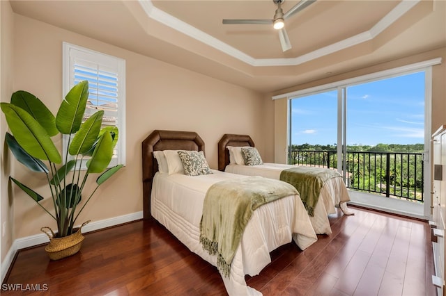 580 El Camino Real Unit 3606, Naples, FL 34119 - bedroom featuring a tray ceiling, dark wood finished floors, multiple windows, access to outside, and ornamental molding