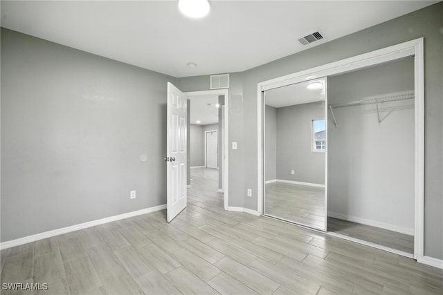 125/127 Gordon Ave S, Lehigh Acres, FL 33973 - unfurnished bedroom with a closet and light wood-type flooring