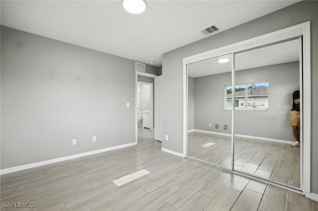 125/127 Gordon Ave S, Lehigh Acres, FL 33973 - unfurnished bedroom with wood finished floors and a closet
