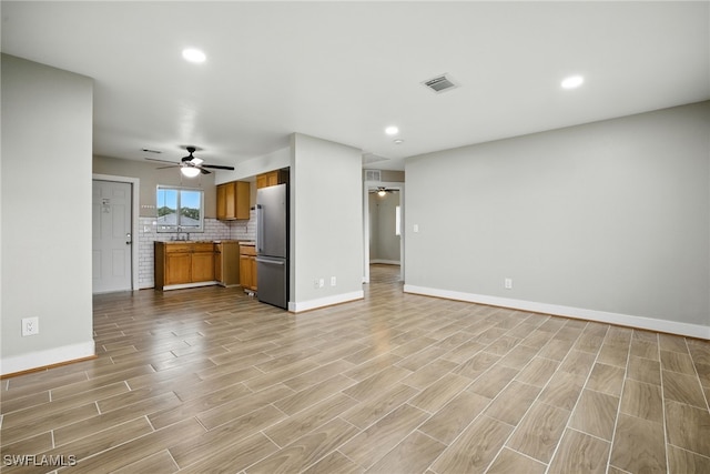 125/127 Gordon Ave S, Lehigh Acres, FL 33973 - unfurnished living room with a ceiling fan, light wood-style flooring, and recessed lighting