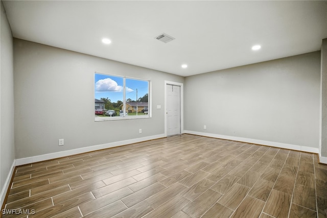 125/127 Gordon Ave S, Lehigh Acres, FL 33973 - empty room featuring wood finished floors and recessed lighting