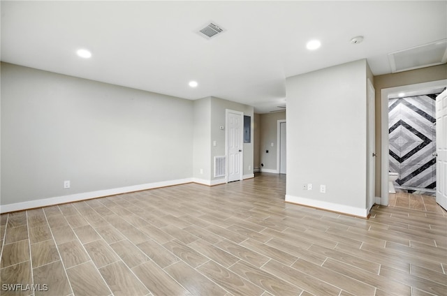 125/127 Gordon Ave S, Lehigh Acres, FL 33973 - unfurnished living room featuring light wood-type flooring and recessed lighting
