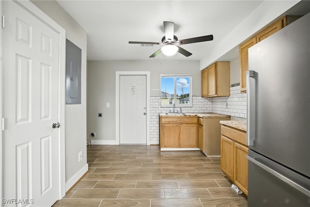 125/127 Gordon Ave S, Lehigh Acres, FL 33973 - kitchen with freestanding refrigerator, a ceiling fan, light countertops, light wood finished floors, and tasteful backsplash