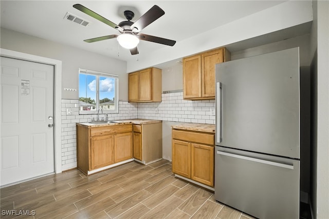 125/127 Gordon Ave S, Lehigh Acres, FL 33973 - kitchen with freestanding refrigerator, a ceiling fan, light countertops, light wood finished floors, and decorative backsplash
