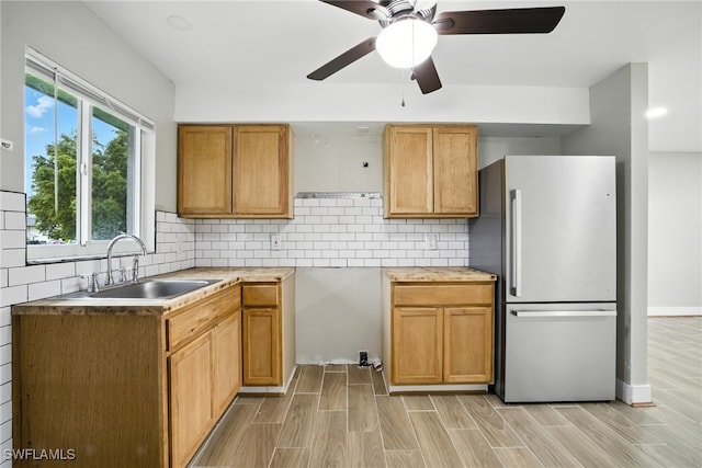 125/127 Gordon Ave S, Lehigh Acres, FL 33973 - kitchen with freestanding refrigerator, a ceiling fan, backsplash, and light wood-style flooring
