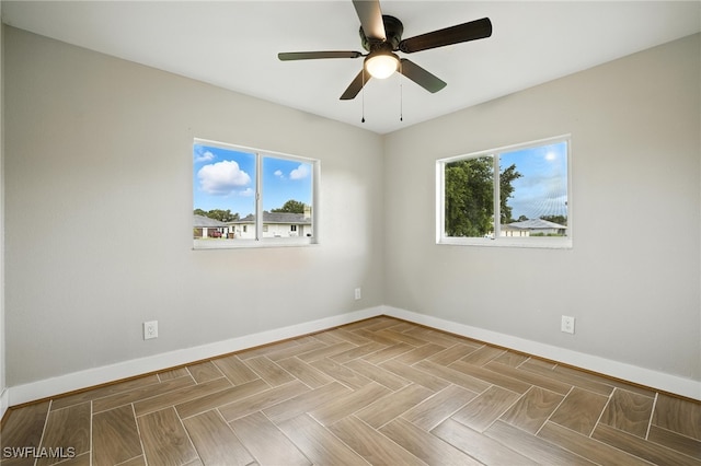 125/127 Gordon Ave S, Lehigh Acres, FL 33973 - unfurnished room featuring baseboards and a ceiling fan