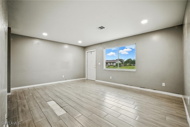 125/127 Gordon Ave S, Lehigh Acres, FL 33973 - spare room featuring light wood-style flooring and recessed lighting
