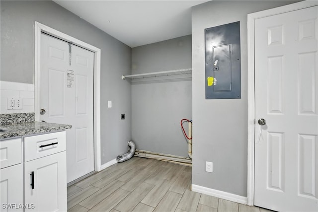 125/127 Gordon Ave S, Lehigh Acres, FL 33973 - laundry area with electric panel, hookup for an electric dryer, cabinet space, and wood finish floors