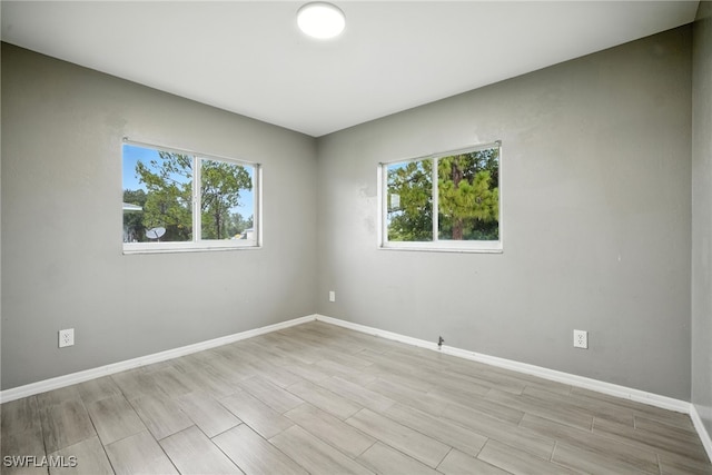 125/127 Gordon Ave S, Lehigh Acres, FL 33973 - spare room with baseboards and wood tiled floors