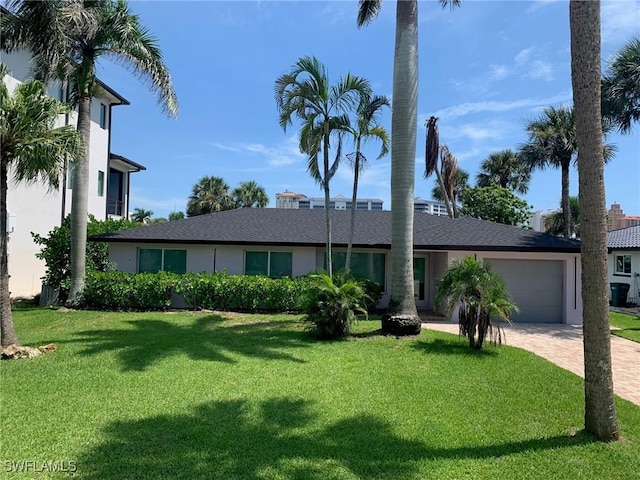 432 Oak Ave, Naples, FL 34108 - ranch-style home with an attached garage, decorative driveway, a front lawn, and stucco siding