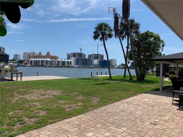 432 Oak Ave, Naples, FL 34108 - view of green lawn featuring a water view, a patio area, and a boat dock