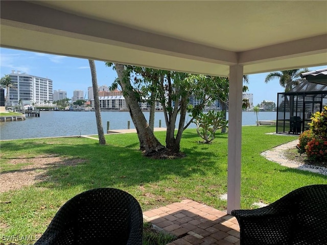 432 Oak Ave, Naples, FL 34108 - view of green lawn featuring a water view, a patio, and glass enclosure
