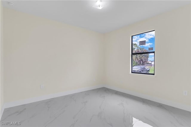 3307 18th St SW, Lehigh Acres, FL 33976 - spare room featuring marble finish flooring and baseboards
