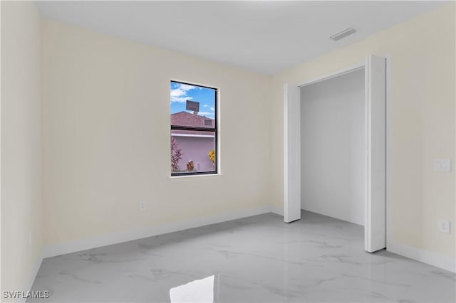 3307 18th St SW, Lehigh Acres, FL 33976 - unfurnished bedroom with light marble finish flooring and baseboards
